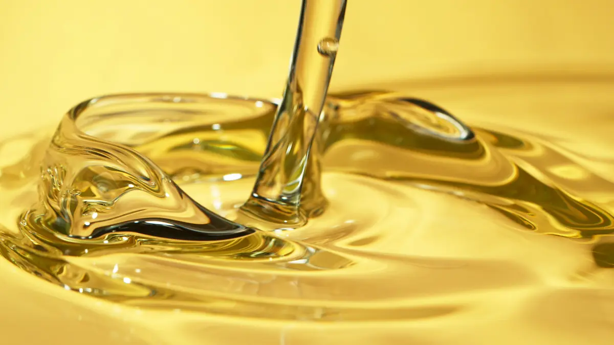 Golden high-purity cannabinoid extract pouring in a smooth, clear ribbon
