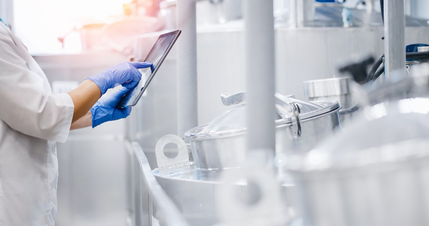A laboratory technician reviewing analytical results on a tablet